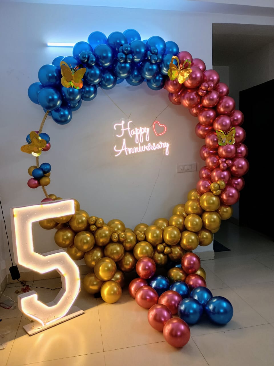 Modern 5th Anniversary Decor with Blue, Gold & Rose Gold Balloon Arch and Neon Sign - anniversary room decoration by ARV Decor