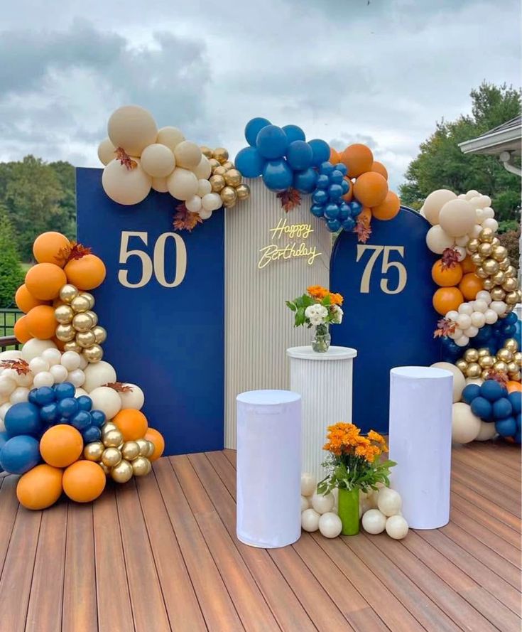 Modern Navy Blue and Gold Milestone Birthday Decor with Balloon Arch and Pedestal Display