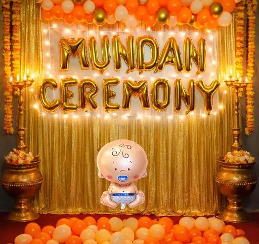 Traditional Mundan Ceremony Decor With Gold Backdrop And Orange Balloon Garland - balloon and flower decoration by ARV Decor