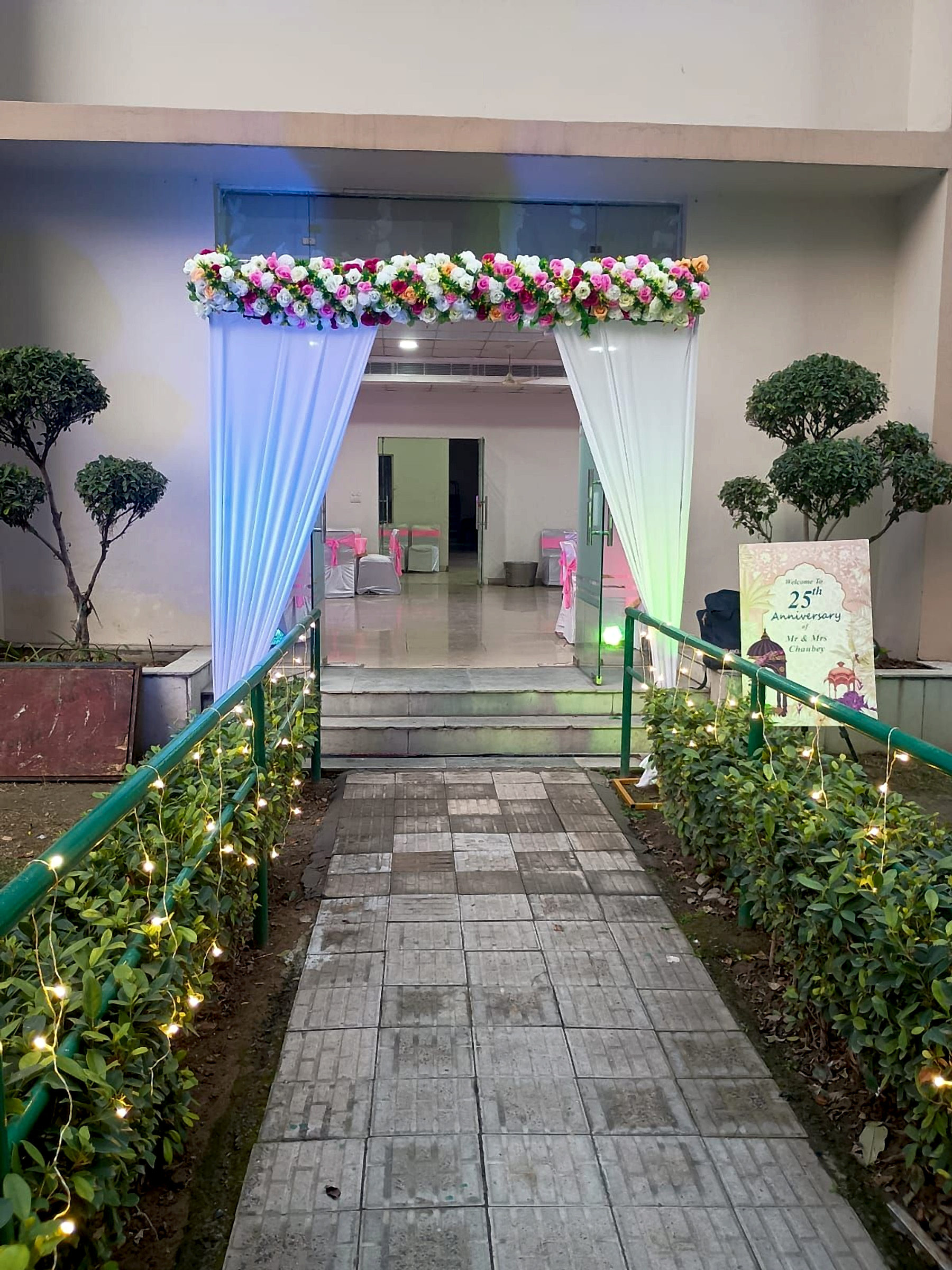 25th Anniversary Floral Entrance Decoration With White Drapes And Pink Flowers - Wedding Knots by ARV Decor thumbnail 2