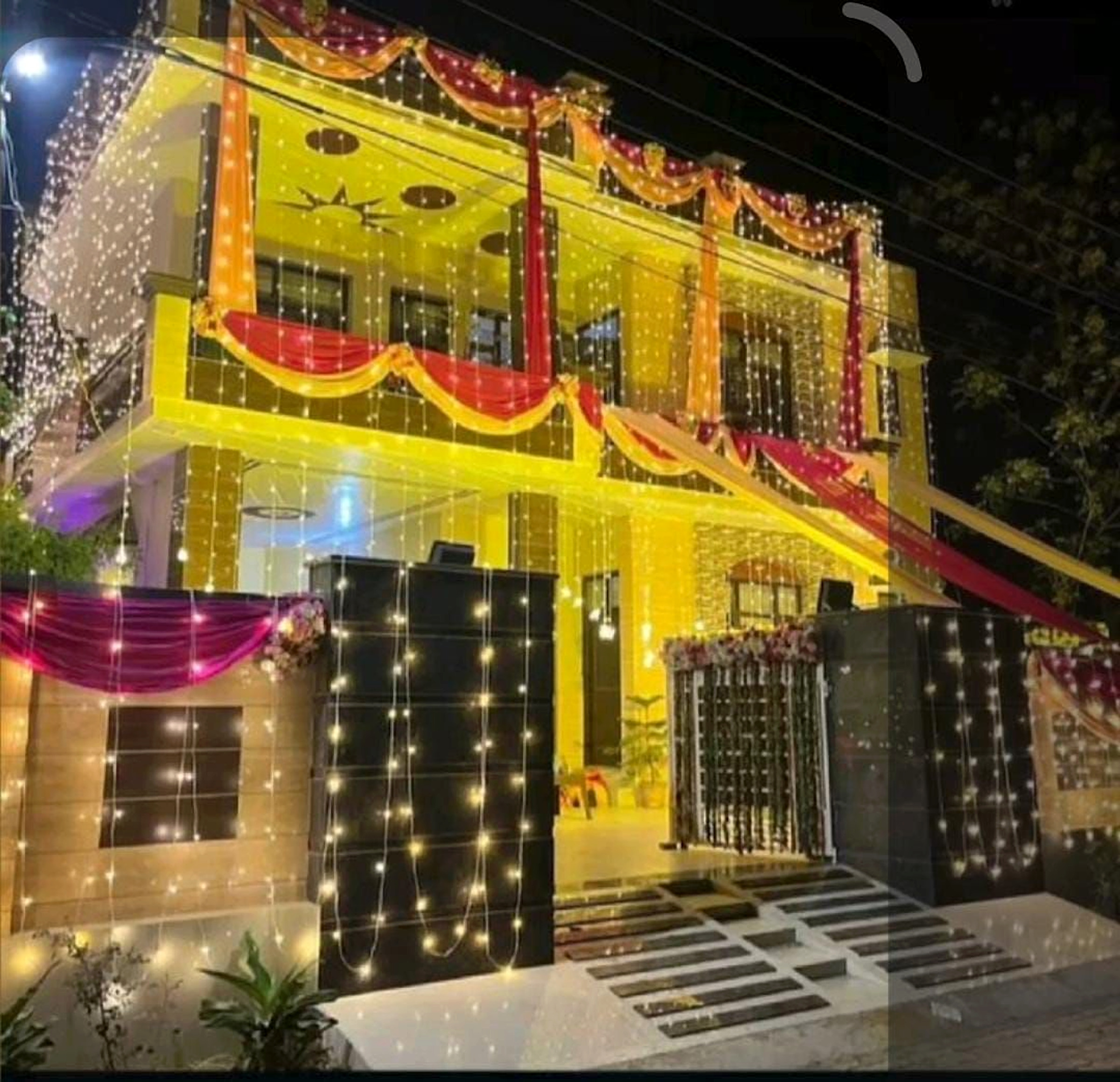 Traditional Wedding House Decor With Yellow And Red Lighting And Drapes - Wedding Knots by ARV Decor thumbnail 2